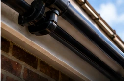 Domestic roofline showing black guttering and fascia